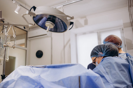 Doctor during surgery in operating room. Professional female doctor performing operation in surgery...