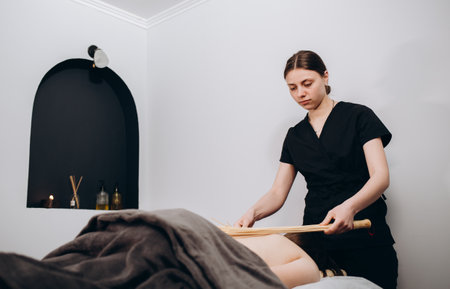 massage with bamboo sticks in spa salon.の写真素材
