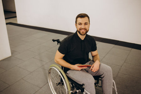 A boy in a wheelchair plays table tennis.の写真素材