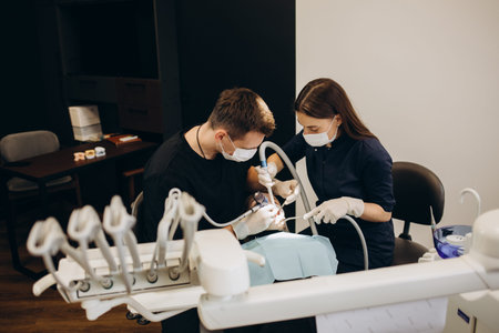 Smiling woman at the dentist's appointment. beautiful positive girl at a routine examination at the dentistの写真素材