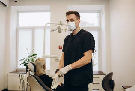 Portrait of male dentist .She standing in her dentist office.の写真素材