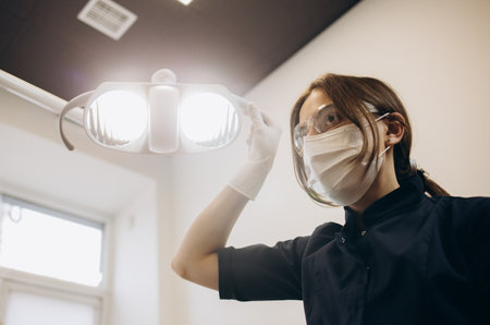 European mid dentist woman smiling while standing in dental clinicの写真素材