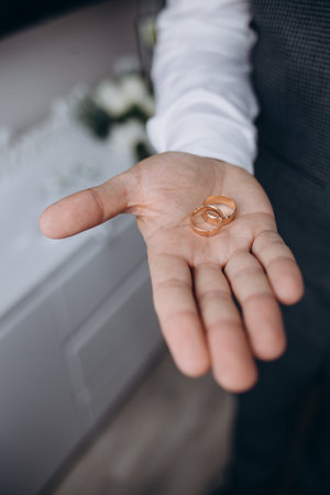 wedding rings on the palm, groom's preparations, preparation of wedding rings for the holiday, photo details, jewelry that symbolizes the marriage bond, a long traditionの写真素材