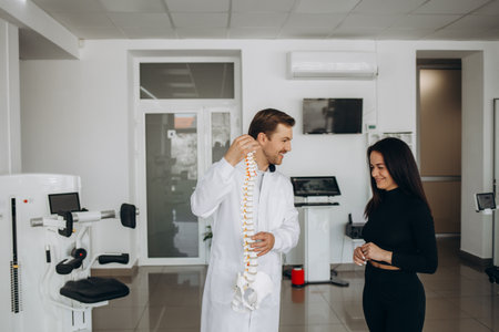 Young woman doing spine checkup at vertebra clinic.の写真素材