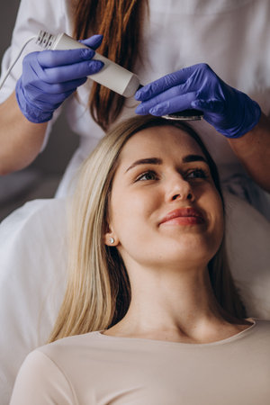 portrait of a young beautiful girl rf face lifting procedure. face care and rejuvenation. Increased...