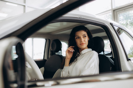 Young woman receiving the keys of her new car.の写真素材