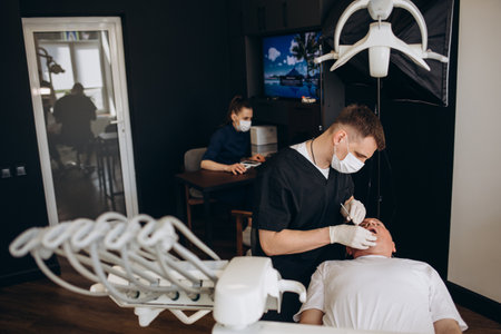 Senior man having dental treatment at dentist's officeの写真素材