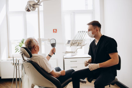 Senior man having dental treatment at dentist's officeの写真素材