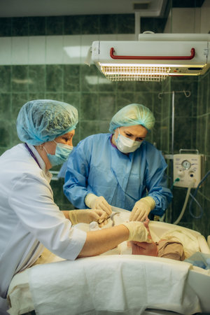 Professional anesthesiologist doctor medical team and assistant is performing baby cesarean section...