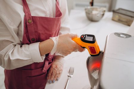 Contactless infrared confectionery thermometer. Professional pastry chef or chocolatier.の写真素材