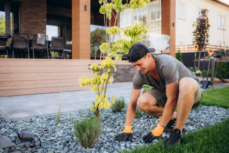 Portrait of a male landscape designer working on the site.