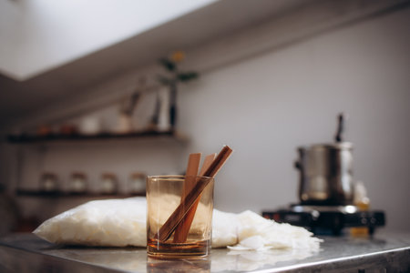 a wick in a glass on a background of painted wax.の写真素材