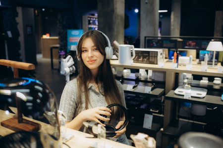 Happy customer choosing headphones in audio storeの写真素材