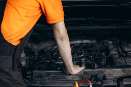 auto mechanic repairing a car engine. Different work tools on foreground. high quality photoの写真素材