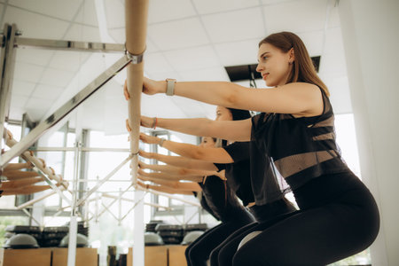 There is a group Pilates class in studio for people of different ages.