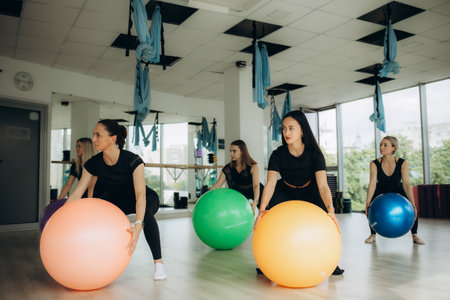 A group of young women go in for sports on fitness balls. high quality photoの写真素材