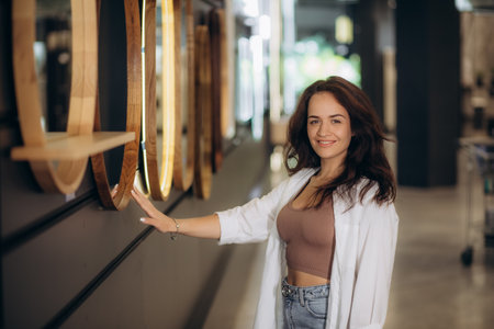 a woman chooses a mirror at home in a store. high quality photoの写真素材