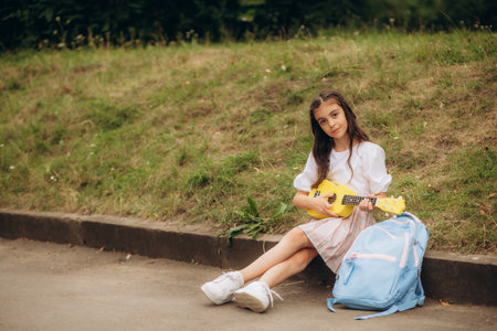 fashionable stylish little rock girl with a guitar. multi-colored pigtails from kanekalon. high quality photoの写真素材