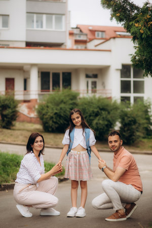 first day at school. mother leads a little child school girl in first grade. high quality photoの写真素材