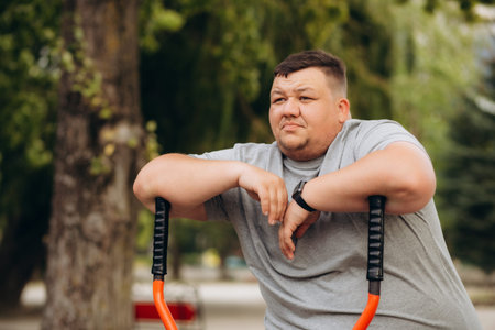 Young overweight man running in park. Fitness lifestyle. High quality photo