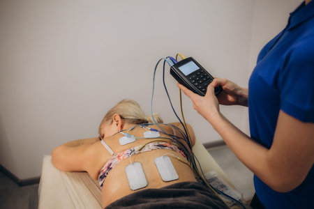 Back Pain Electrode Stimulation And Training. Electrotherapy. High quality photo