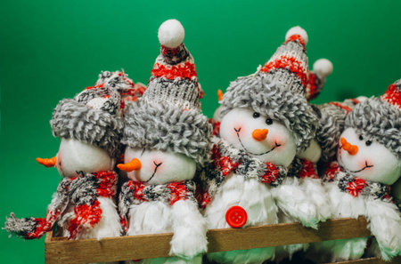 Cute snowman isolated on green backgroundの写真素材