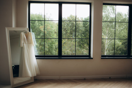 Wedding dress hanging on a wooden chandelier. High quality photo