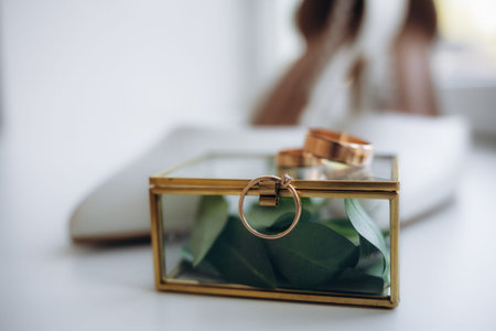 Bride's shoes and wedding ring on a glass table. Wedding traditional bride's accessories in the form...