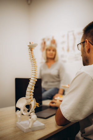Senior lady in the doctor's office, she has back pain and rheumatism symptoms. High quality photo