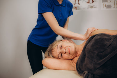 senior woman at an appointment with a chiropractorの写真素材