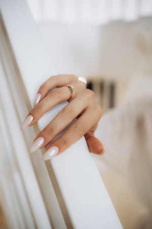 Close-up of woman's hands holding wedding ring. Focus on ring. High quality photoの写真素材