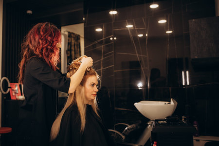 Attractive delighted woman sitting in the hairdressing salon . High quality photo