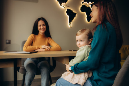 mother and daughter choose a tourist tour in a travel agencyの写真素材