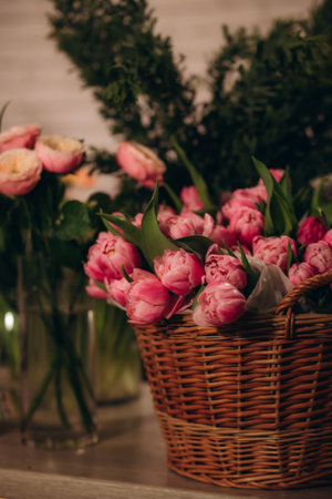 wooden basket with pink tulips in flower shopの写真素材