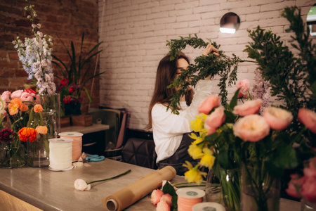 a female florist works in a flower shopの写真素材