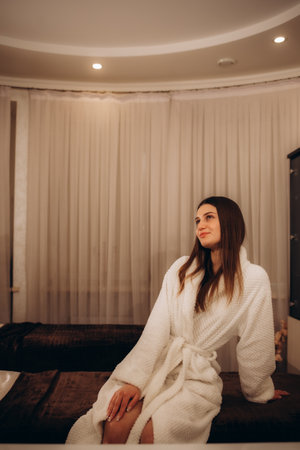 Relaxed young woman waiting for treatment in massage roomの写真素材