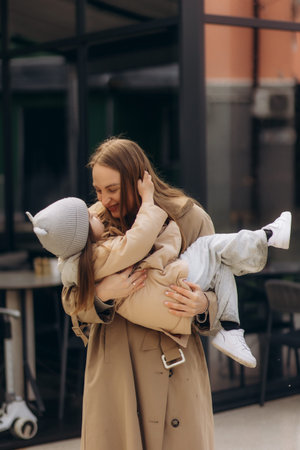 Mother and little daughter playing together in a streetの写真素材
