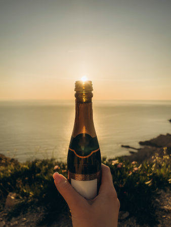 Orange sunset falling into a glass bottleの写真素材