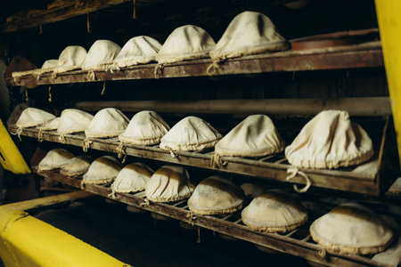 The process of baking bread. Unleavened bread. Baker's hand in the frame. Sprinkle bread molds with...