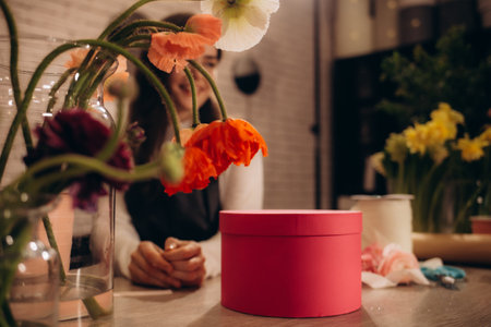 Florist creating beautiful bouquet at wooden table indoors, closeupの写真素材
