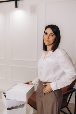 A woman puts clothes in an organiserの写真素材