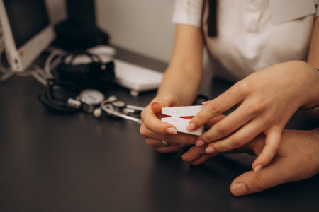 doctor measuring blood sugar young menの写真素材