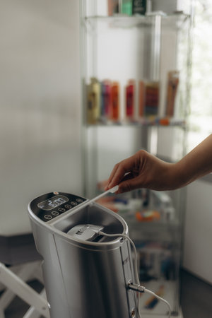 a female dentist performs teeth whitening for a patientの写真素材