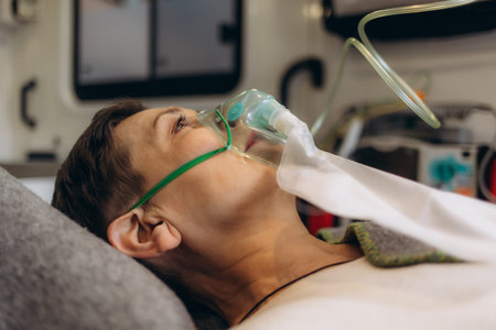 Unconscious Woman With Oxygen Mask, ambulance interiorの写真素材