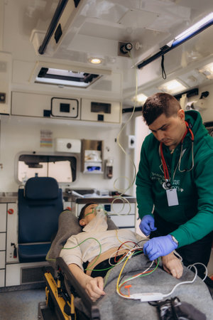Paramedic using oxygen mask to help unconscious womanの写真素材