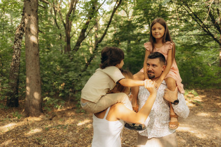 Parents with small children playing in the forestの写真素材