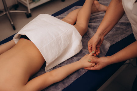 osteopath does physiological and emotional therapy for kid. pediatric osteopathy treatment session. alternative medicine. taking care of the child's health.の写真素材