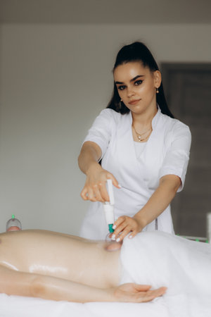 A traditional session captures blood cupping therapy, traditional technique and equipment used in this ancient therapeutic practice. Believed to benefit health.の写真素材