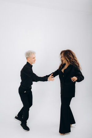 Social dance, bachata, kizomba, zouk, tango concept - Man hugs woman while dancing over white background with copy spaceの写真素材