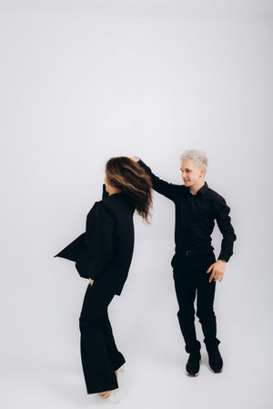 beauty couple dancing social dance kizomba or bachata or semba on light grey backgroundの写真素材